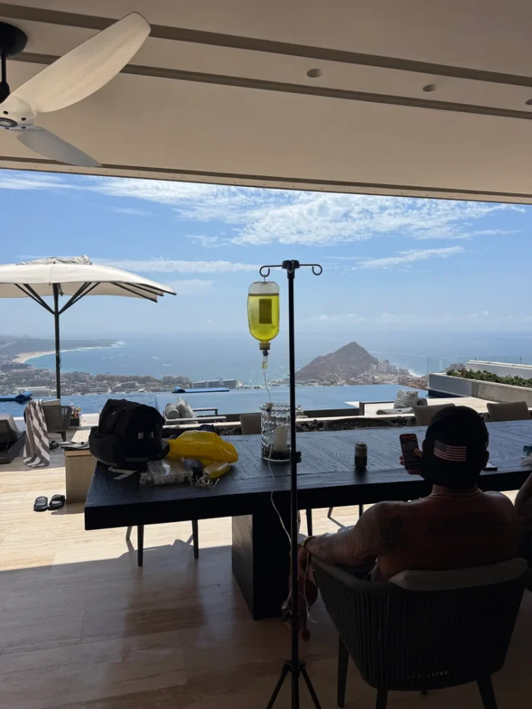 Mobile IV setup on a villa terrace overlooking Cabo